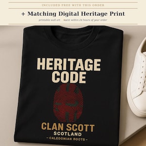 May include: A black t-shirt featuring the text HERITAGE CODE in cream, a red and green fingerprint graphic, and the text CLAN SCOTT SCOTLAND - CALEDONIAN ROOTS - in gold. A white sneaker is positioned to the right of the folded t-shirt.