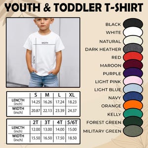 May include: A white youth and toddler t-shirt with size and color options. The image shows a child wearing the shirt, with measurements in inches for length and width. Color options include black, white, and navy.