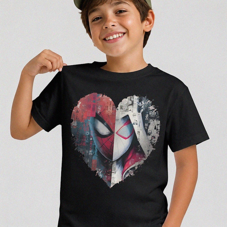 May include: A black short-sleeved t-shirt featuring a large heart-shaped graphic on the chest. The graphic is split down the middle, showing a red and black masked character on the left and a white and red masked character on the right.