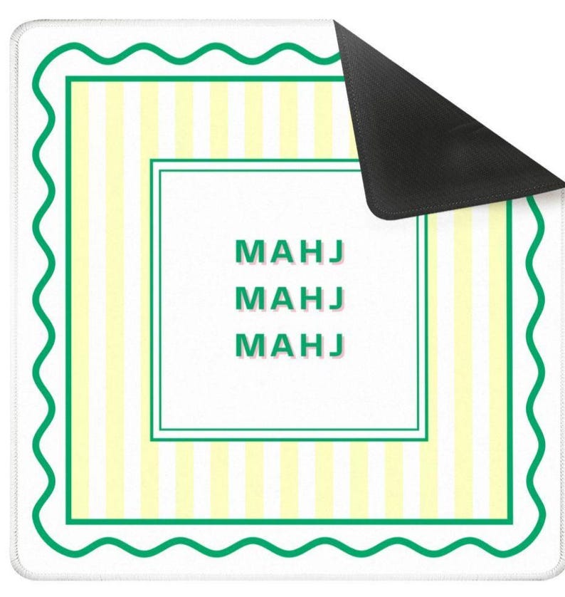 May include: A white rectangular mousepad with a green wavy border and a green and yellow striped interior. The center features the word "MAHJ" repeated three times in green.