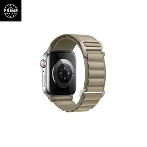 May include: A silver smartwatch with a tan fabric band. The watch face is black with a circular design. The band has a magnetic clasp. The brand logo "PRIME WRIST" is in the upper left corner.