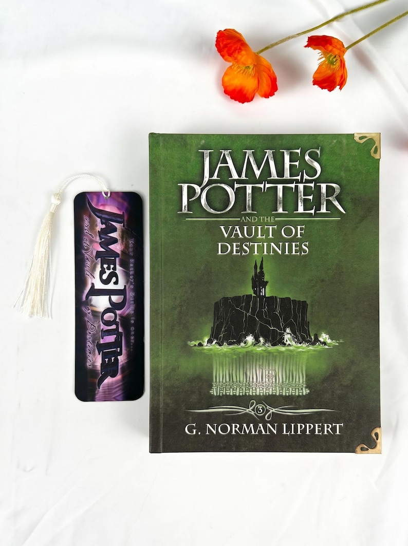 May include: A hardcover book titled James Potter and the Vault of Destinies by G. Norman Lippert with a green cover featuring a dark castle illustration, paired with a matching vertical bookmark that has a white tassel and purple text.