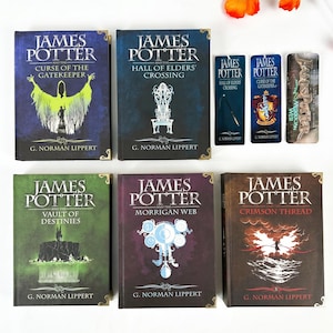 May include: Five hardcover books titled James Potter by G. Norman Lippert with distinct cover art in blue, green, purple, and brown, accompanied by three matching vertical bookmarks featuring character and title graphics, all arranged on a white surface.