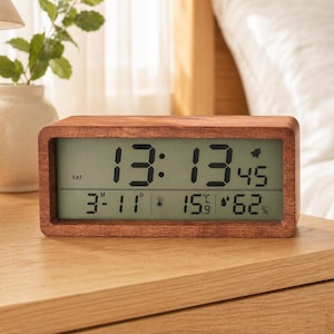 May include: A rectangular wooden digital clock displaying the time, date, temperature, and humidity. The clock face shows 1:13 PM, March 11th, 60 degrees Fahrenheit, and 62% humidity. The clock is on a wooden nightstand.