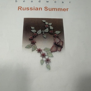 May include: A printed page titled PETERSEN bead wear Russian Summer featuring a photograph of a beaded necklace with green leaves, pink flowers, and a large butterfly motif. The text includes copyright information by Huib Petersen from 2007.