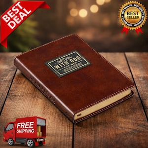 May include: A brown leather-bound book with gold-colored edges and the text "One Minute With God For Men" on a black and gold label. The book is on a wooden surface with a "Best Deal" and "Best Seller" seal.