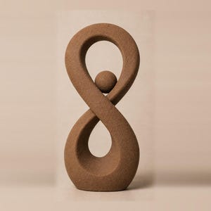 May include: A brown, textured sculpture shaped like a vertical infinity symbol with a small, round sphere suspended in the upper loop. The object has a matte, granular surface finish and a continuous, flowing form that creates two distinct open spaces.