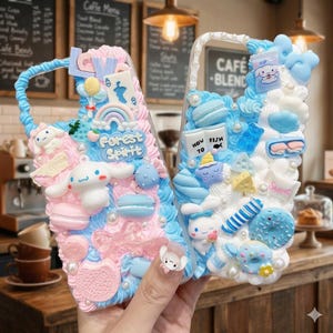 May include: Two decorative phone cases with a whimsical design. One case features pink and blue frosting with a rainbow, macarons, and the text "Forest Spirit". The other case has blue and white frosting with a cartoon character and the text "Cafe Blend".