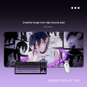 May include: A large rectangular mouse mat featuring an anime-style illustration. The mat includes a purple and black keyboard, a white mouse, and the text "Creative large non-slip mouse pad" and "RUBBER MOUSE PAD". The mat measures 90cm x 40cm.