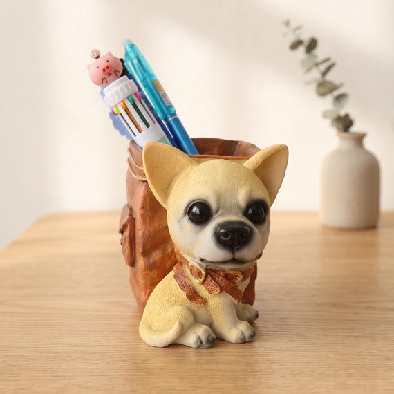 A hand-painted resin Chihuahua that moonlights as a pen holder — functional desk art that doubles as a sweet pet memorial piece.