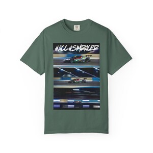 May include: Green t-shirt with a graphic of race cars on a track. The graphic includes the text "#ACC #SIMRACER" in white. The shirt is made of a soft material and has a crew neck.
