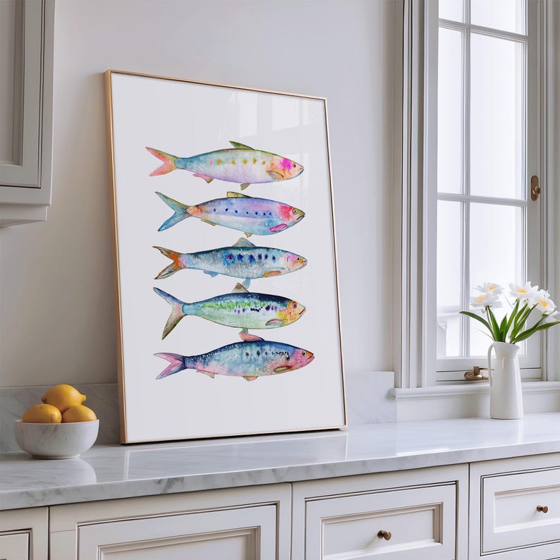 May include: A framed watercolor painting of five colorful fish, arranged vertically on a white background. The fish are painted in shades of blue, green, pink, and purple.