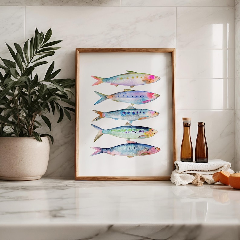 May include: A framed watercolor painting of six colorful fish arranged vertically. The fish are painted in shades of blue, green, purple, and pink, with a white background.