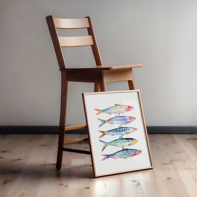 May include: A framed watercolor painting of five colorful fish, each with a different pattern and color, arranged in a row on a white background.