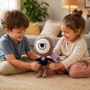 May include: A plush doll with a large, round, brown head featuring a single white eye with a black pupil. The doll has a black shirt, purple arms, and tan legs. Two children are holding the doll on a beige carpet.