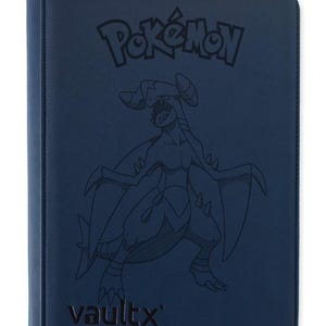 May include: A dark blue zippered trading card binder featuring an embossed Garchomp character illustration on the front cover. The cover displays the Pokémon logo at the top and the VaultX brand name at the bottom in dark, subtle lettering.