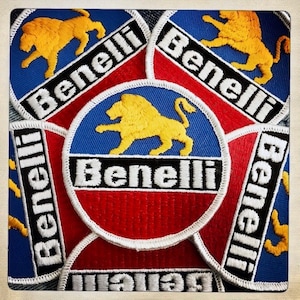 May include: Five embroidered patches featuring a lion and the word "Benelli" in white lettering on a blue, red and white background.