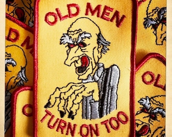 May include: Yellow embroidered patch with red stitching. The patch features a cartoon image of an old man with a menacing expression and the text "Old Men Turn On Too".