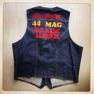 May include: A dark blue denim vest with the words "SUPER 44 MAG BLACK HAWK" in red and yellow letters.