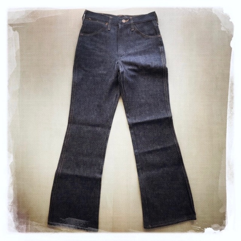May include: A pair of dark blue denim jeans with a wide leg and a high waist.