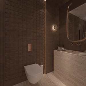 May include: A modern bathroom interior featuring a white toilet, a built-in sink, and a large mirror with a gold frame. The walls are a dark brown with a grid pattern, and a circular wall sconce provides soft lighting.