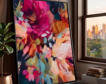 May include: A framed abstract floral painting with vibrant colors. The artwork features bold brushstrokes in shades of pink, orange, yellow, and blue against a dark background. The painting is displayed indoors, leaning against a wall near a window.