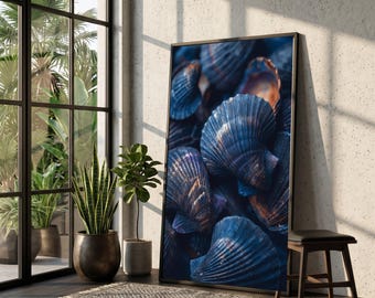 May include: A framed art print featuring a close-up of numerous blue seashells with textured surfaces. The shells have a gradient of colors, with hints of orange and brown. The artwork is displayed in a room with natural light and plants.