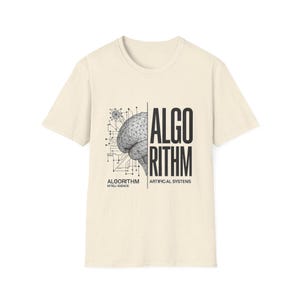 May include: A cream-colored short-sleeve t-shirt featuring a black graphic of a wireframe brain connected to circuit lines. The text ALGORITHM is printed in large letters, with ALGORITHM INTELI IGENCE and ARTIFICAL SYSTENIS below.