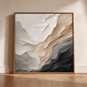 May include: Square framed abstract art piece with a textured surface. The artwork features a layered design with a color palette of white, beige, gray, and black. The frame is made of wood.