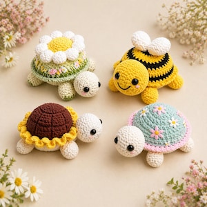 May include: Four crocheted turtle toys. One is decorated with a daisy, another with a bee design, a third with a sunflower, and the last with small flowers. Each turtle has a white head, legs, and a smiling face.