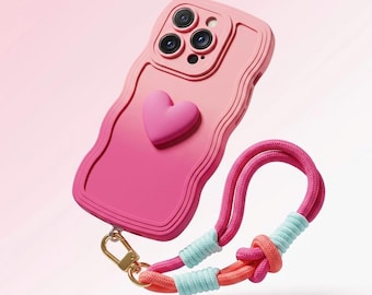 Funda para iPhone con diseño de corazón degradado y correa de muñeca con cordón. Cubierta de silicona con diseño de olas.