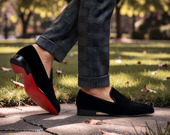 Christian Louboutin Dandelion black suede loafers featuring the signature red sole.