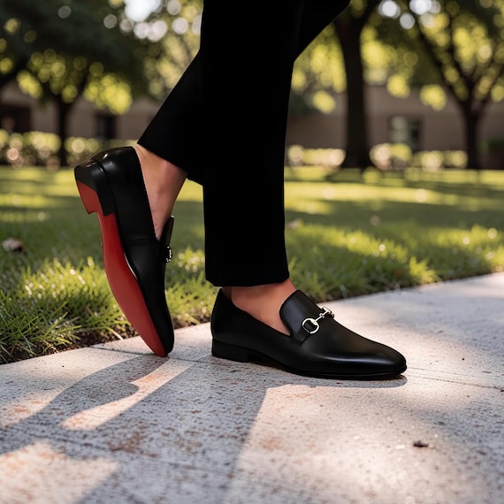 Christian Louboutin black leather horsebit loafers, featuring a slip-on design and a red sole