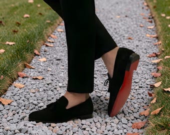 Christian Louboutin Dandelion black suede loafers featuring the signature red sole.
