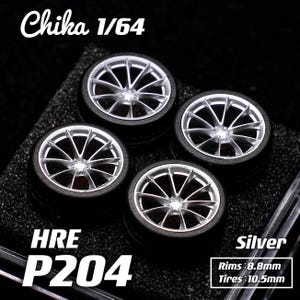 May include: Four silver and black model car wheels. The wheels have a multi-spoke design with black tires. The text "Chika 1/64", "HRE P204", and "Silver" are visible. Rims are 8.8mm and tires are 10.5mm.