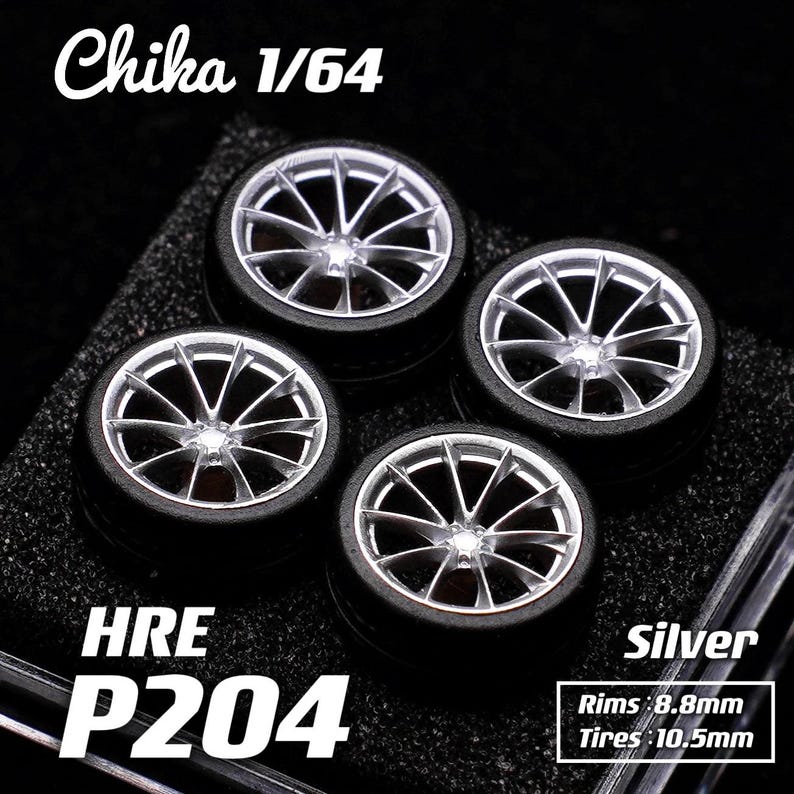 May include: Four silver and black model car wheels. The wheels have a multi-spoke design with black tires. The text "Chika 1/64", "HRE P204", and "Silver" are visible. Rims are 8.8mm and tires are 10.5mm.