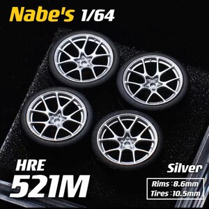 May include: Four silver-colored model car wheels with black tires. The wheels have a multi-spoke design. The text "Nabe's 1/64", "HRE 521M", and "Silver" are visible. Rim size is 8.6mm, and tires are 10.5mm.
