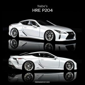 May include: Two white Lexus LC500 model cars with chrome wheels are displayed against a black background. The text "Nabe's HRE P204" is at the top, and "PHOTOGRAPH BY SKYO" is at the bottom. The cars are reflected in the glossy surface.