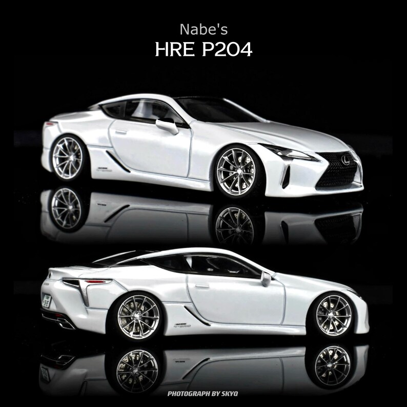 May include: Two white Lexus LC500 model cars with chrome wheels are displayed against a black background. The text "Nabe's HRE P204" is at the top, and "PHOTOGRAPH BY SKYO" is at the bottom. The cars are reflected in the glossy surface.
