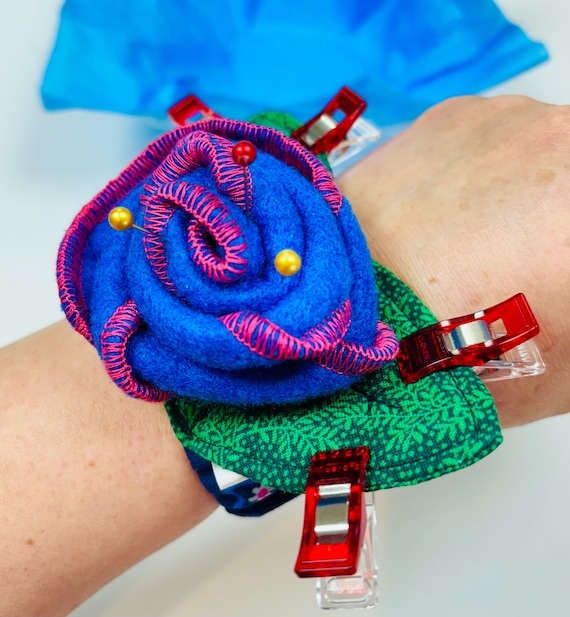 Wrist Pincushion Rose with Blue and Pink awareness ribbon.