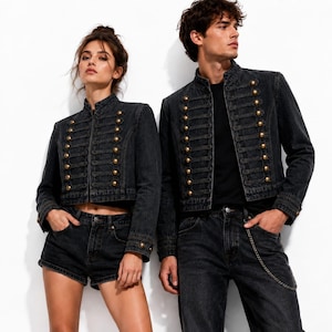 May include: Two black denim jackets featuring a high collar, long sleeves, and a front closure with two vertical rows of gold-toned buttons connected by decorative cord loops. The jackets are worn over black tops with black denim bottoms.
