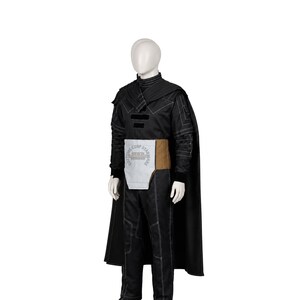 May include: A black costume set featuring a long-sleeved top with white stitching, matching trousers, and a cape. A light grey and tan waist belt is worn over the top, featuring the text "COSTUME COSP STAR WARS" printed on the front panel.