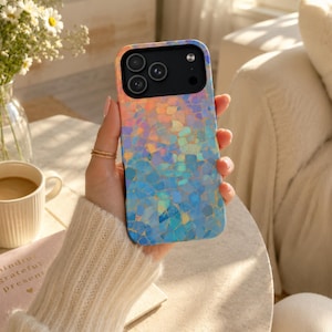 May include: A smartphone case featuring a vibrant, iridescent mosaic pattern that transitions from warm orange and pink tones at the top to cool blue and purple shades at the bottom. The case has a black camera module with three circular lenses.