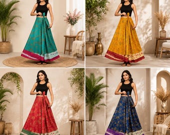 May include: A collection of four floor-length wrap skirts, each paired with a black sleeveless crop top. The skirts feature intricate gold-toned patterns on teal, mustard yellow, red, and navy blue fabric, finished with a wide floral border.