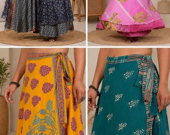 May include: A collection of four wrap skirts featuring diverse patterns and colors, including a dark blue floral print, a pink floral design, a yellow paisley motif, and a teal skirt with white geometric patterns, all with tie-waist closures.