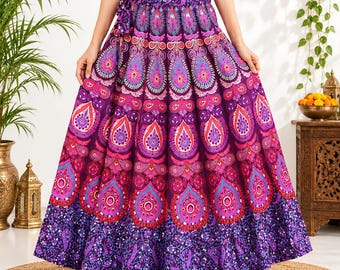 May include: A floor-length maxi skirt in deep purple, featuring a vibrant, repeating paisley and mandala-inspired pattern in shades of pink, magenta, and light blue. The skirt has a wide, gathered waistband with a side tie and a ruffled hem.
