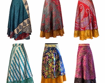 May include: Six long wrap skirts featuring diverse patterns and colors, including teal, red, paisley, floral, and striped designs. Each skirt has a layered appearance with a distinct hemline, showcasing various fabric prints and vibrant color combinations.