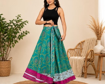 May include: A black sleeveless tank top paired with a floor-length wrap skirt in teal green featuring a gold circular floral pattern. The skirt has a wide magenta border at the hem with white and blue accents and a matching tie at the waist.