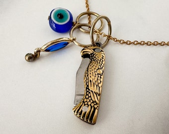 Horus Knife Necklace - Vintage Gold-Tone Falcon Penknife, Evil Eye Bead, Blue Crystal Charm & Reclaimed Chain Statement Necklace