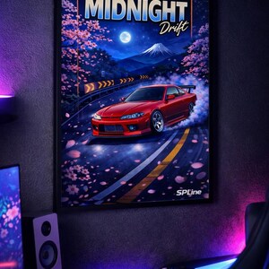 May include: A framed poster featuring a red sports car drifting on a mountain road at night. The poster has the words "MIDNIGHT Drift" at the top, with a full moon and cherry blossoms in the background. The SPLine logo is at the bottom.